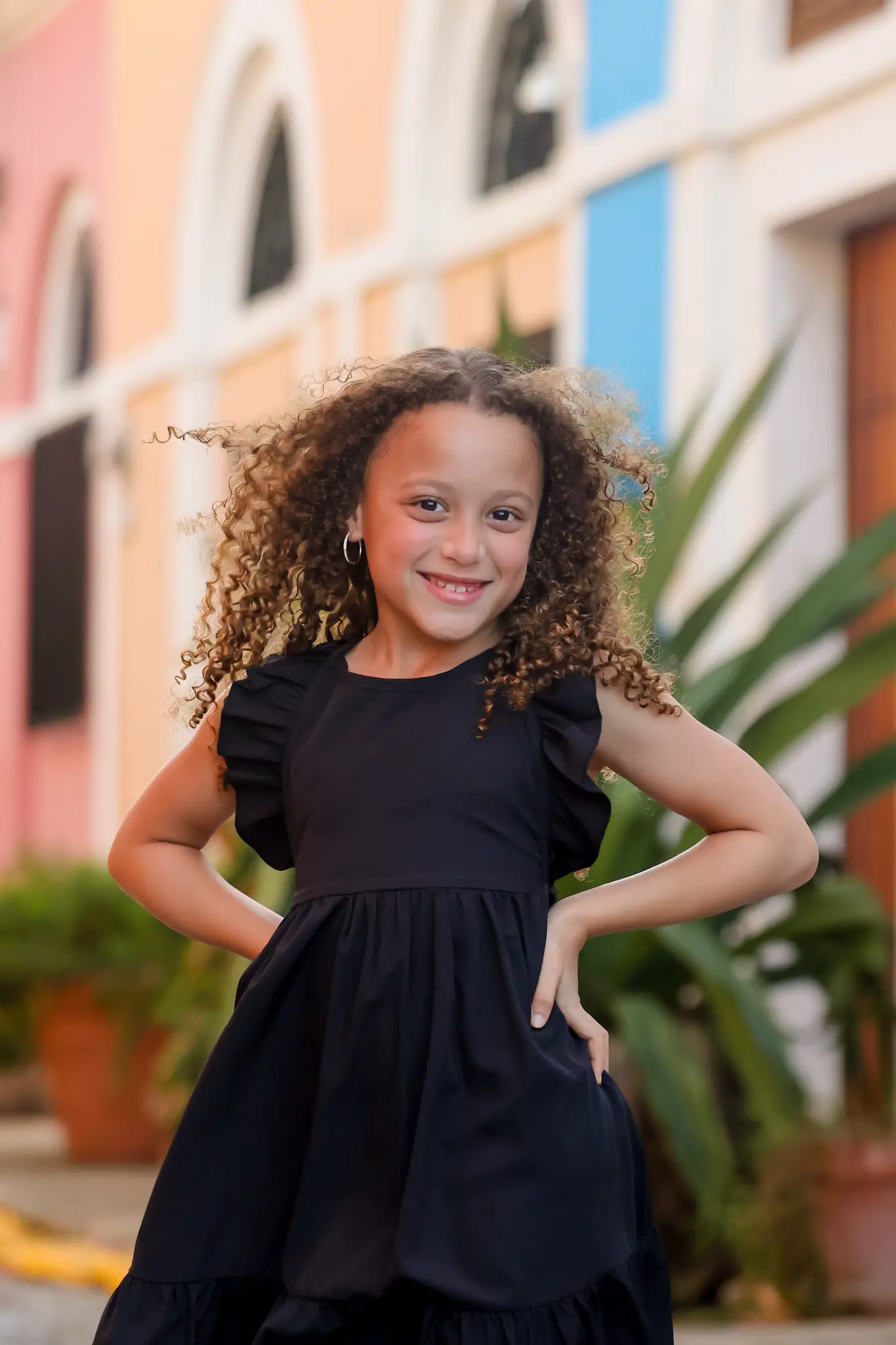 Young girl standing in front of colorful Old San Juan architecture during a family session, photographed by Olga Thomas