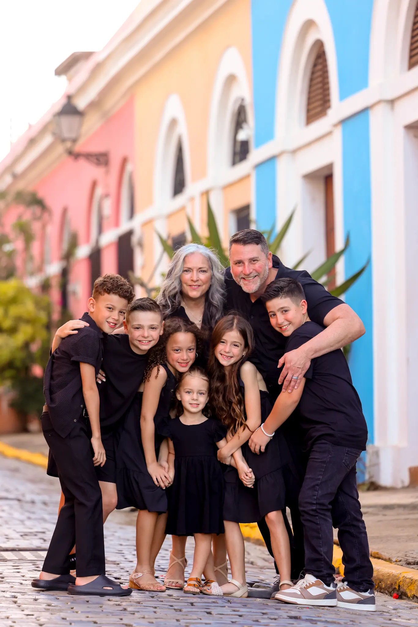 Family group together on a colorful Old San Juan street, photographed by Olga Thomas