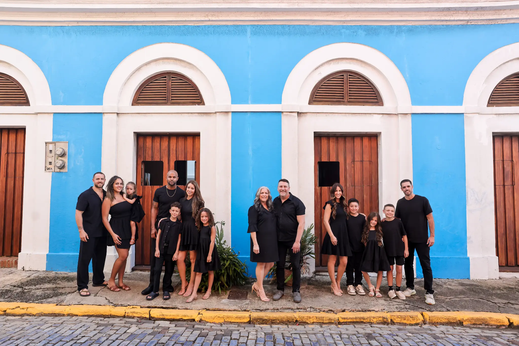 Multi-generational family gathered in front of a blue Old San Juan building, photographed by Olga Thomas