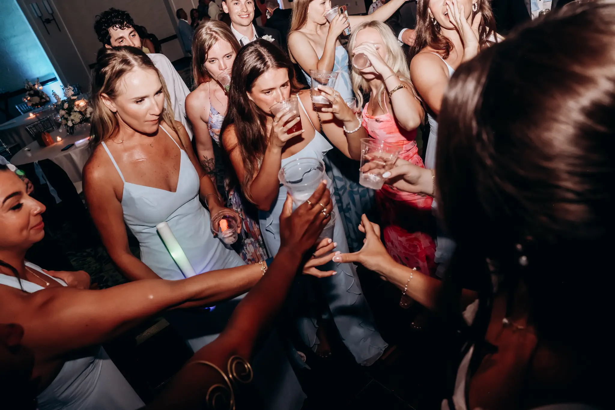 Group of wedding guests celebrating together on a dance floor