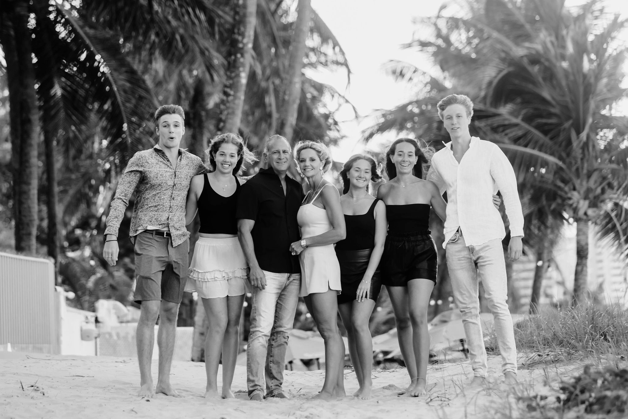 Multi-generational family standing together during an outdoor portrait session, photographed by Olga Thomas