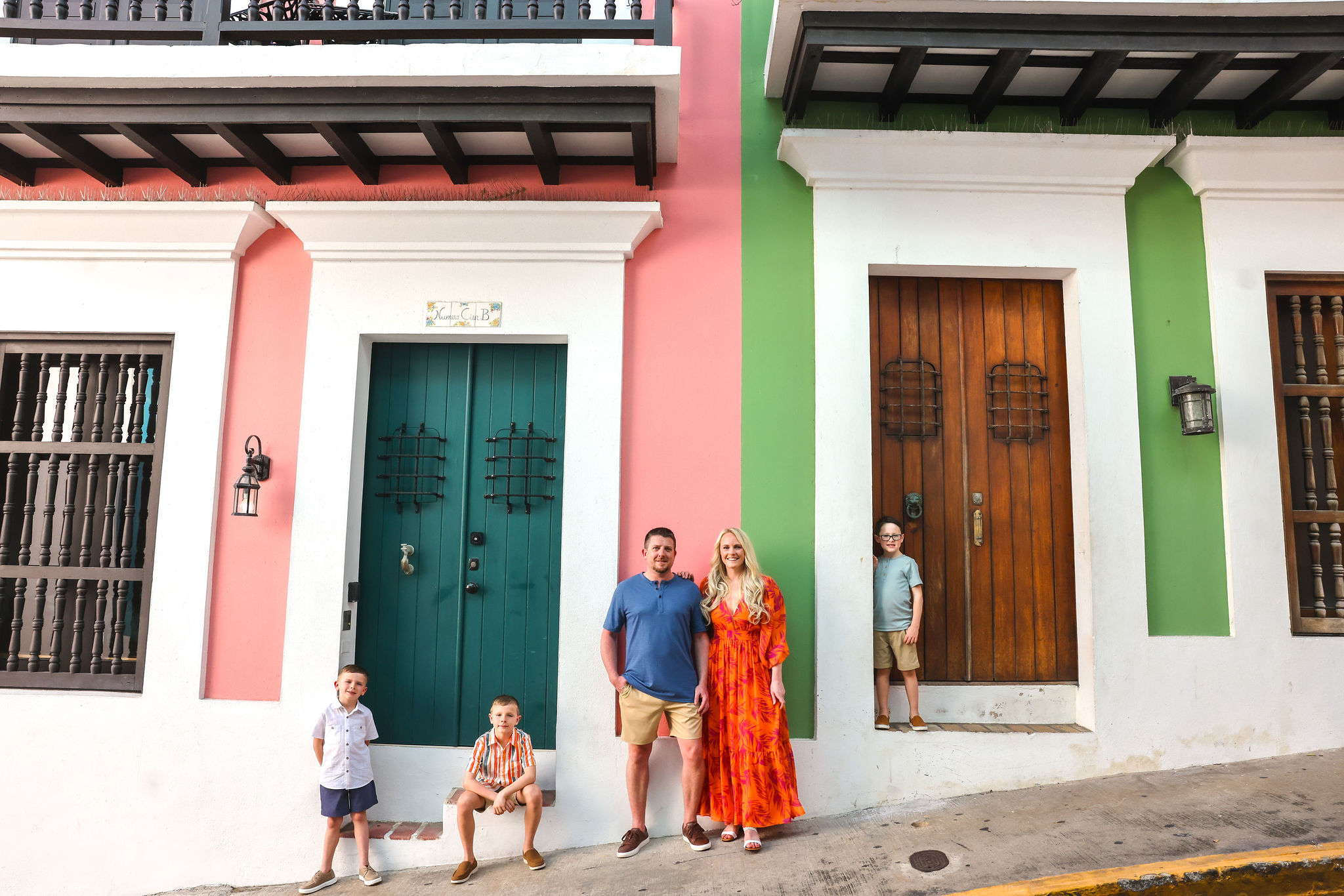 Family pausing beside colorful doors in Old San Juan, Puerto Rico, photographed by Olga Thomas