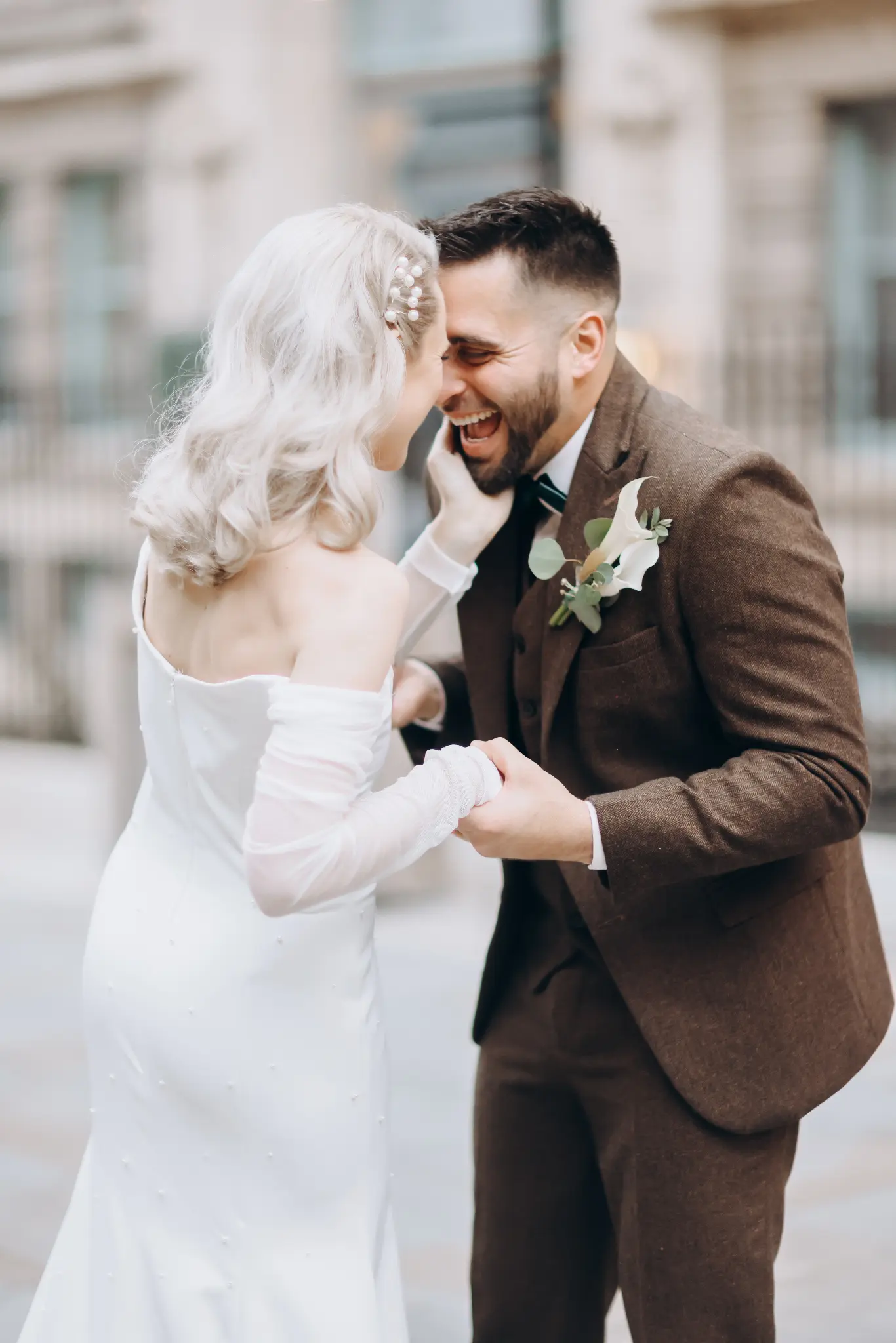 Wedding couple embracing in a softly lit historic courtyard setting