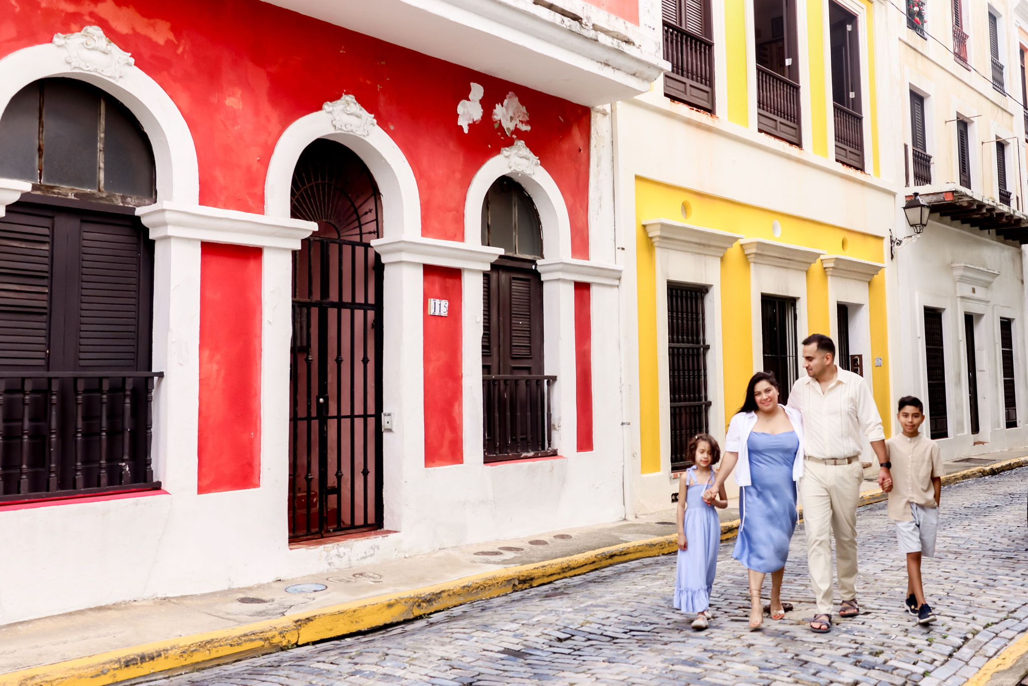 Family walking on a colorful cobblestone street in Old San Juan, Puerto Rico, photographed by Olga Thomas
