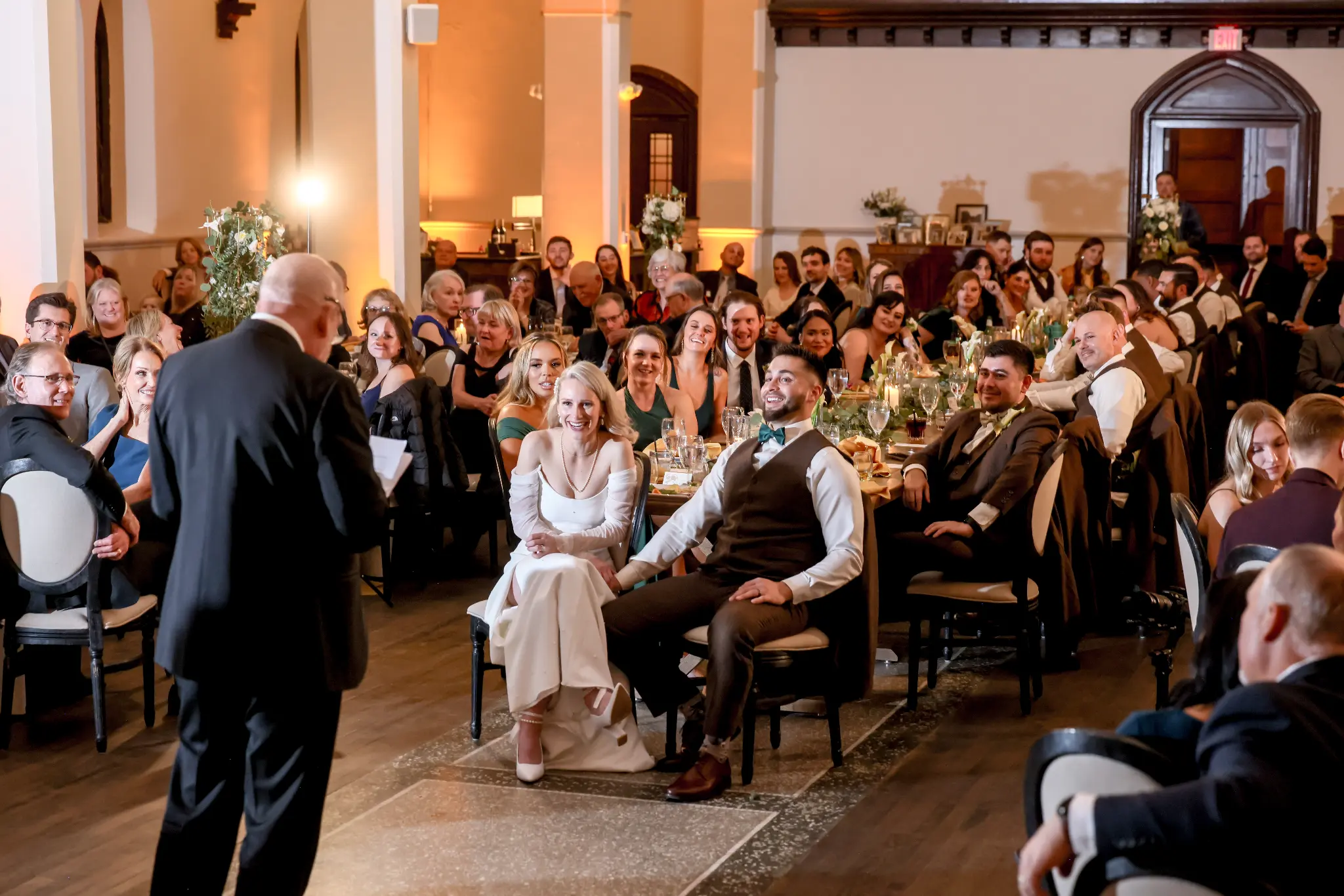 Bride dancing with an older family member while wedding guests watch