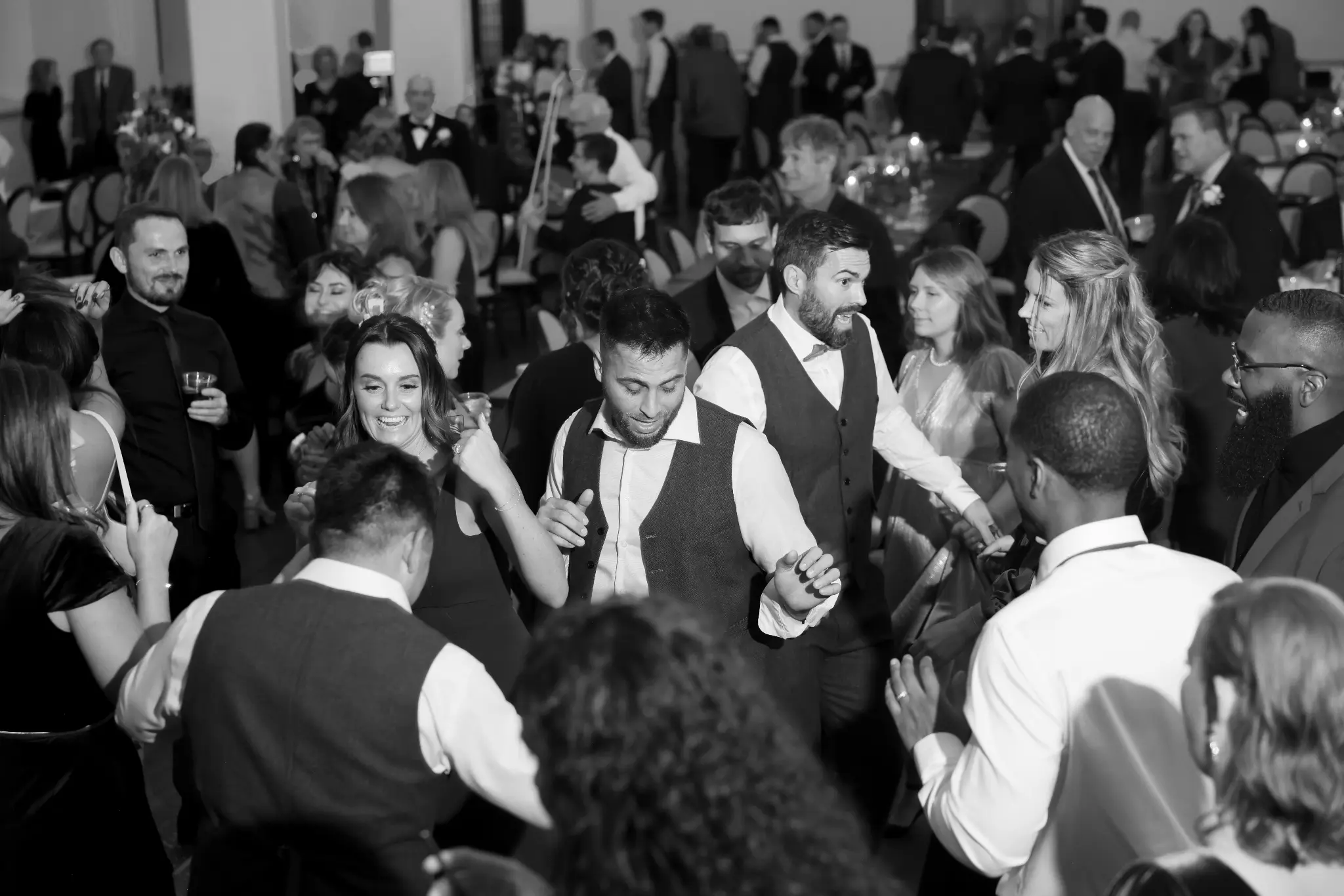 Black-and-white overhead view of a full wedding dance floor