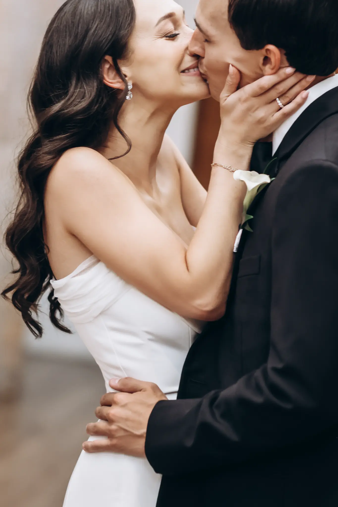 Bride touching groom’s face during an intimate wedding portrait