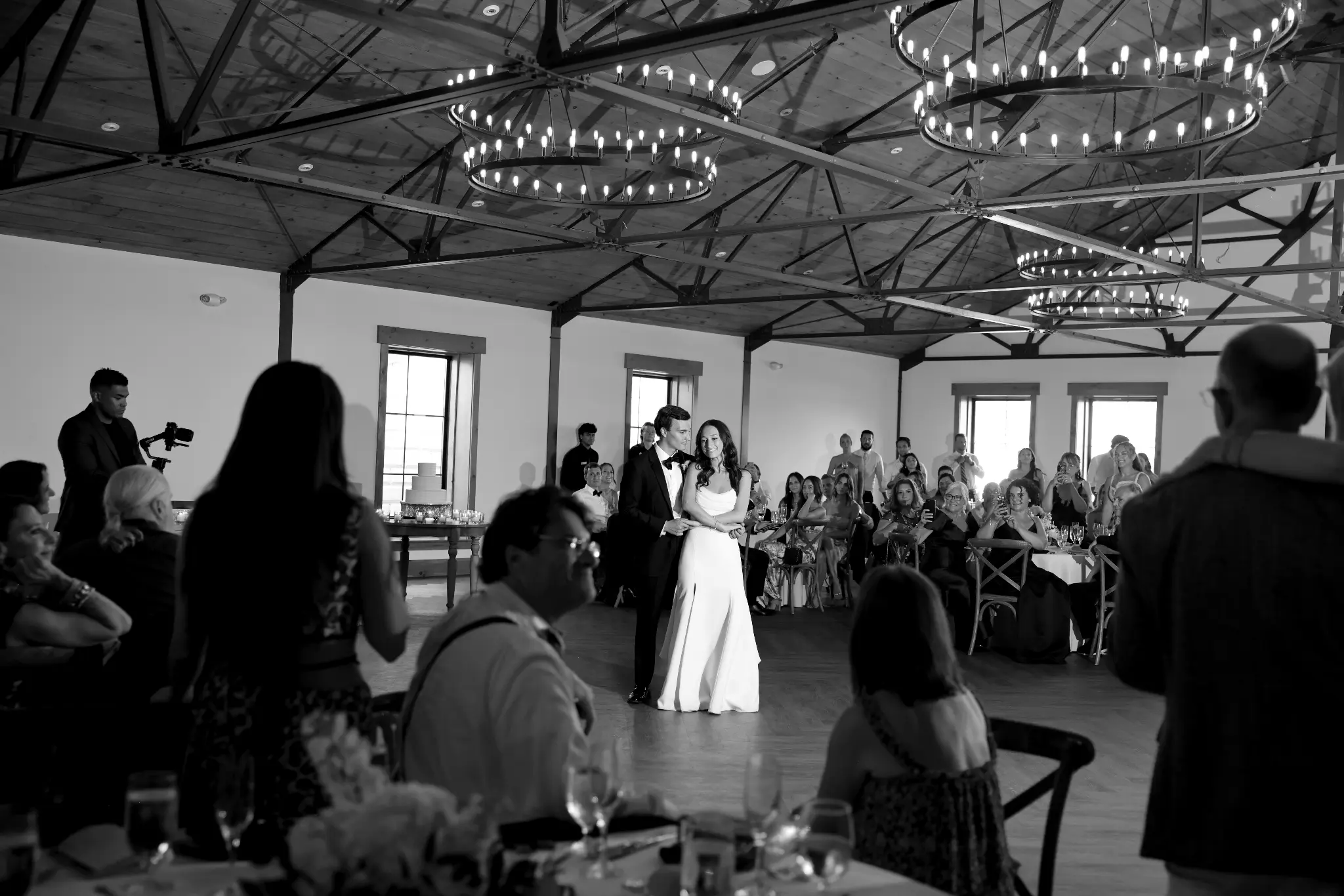 Wide black-and-white wedding reception view with a couple dancing
