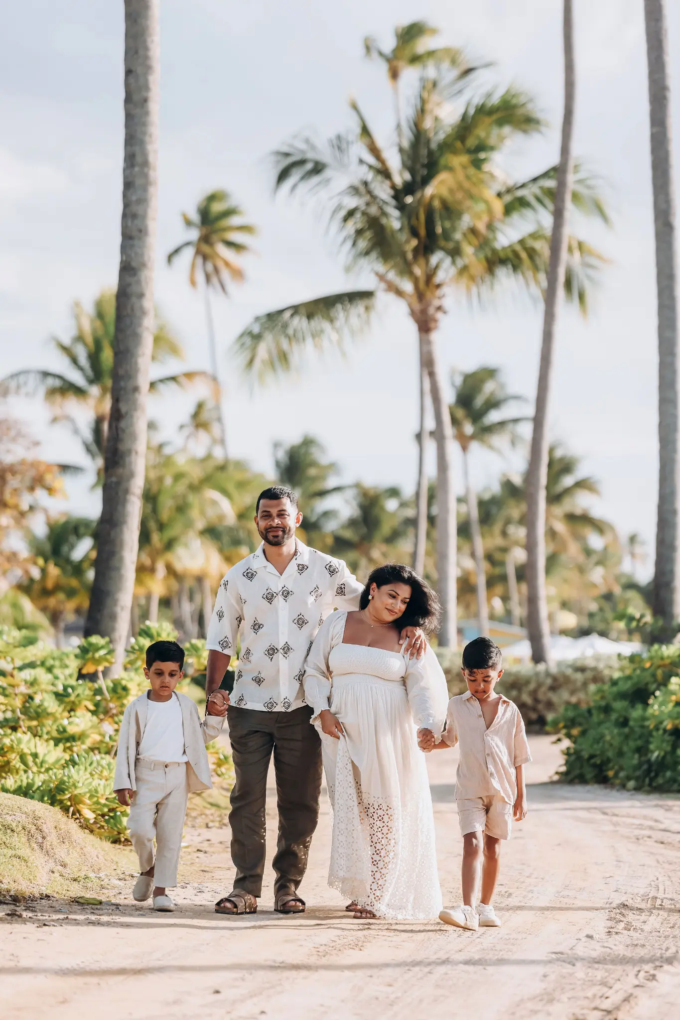 Family walking together beneath palms in a lush Puerto Rico setting, photographed by Olga Thomas