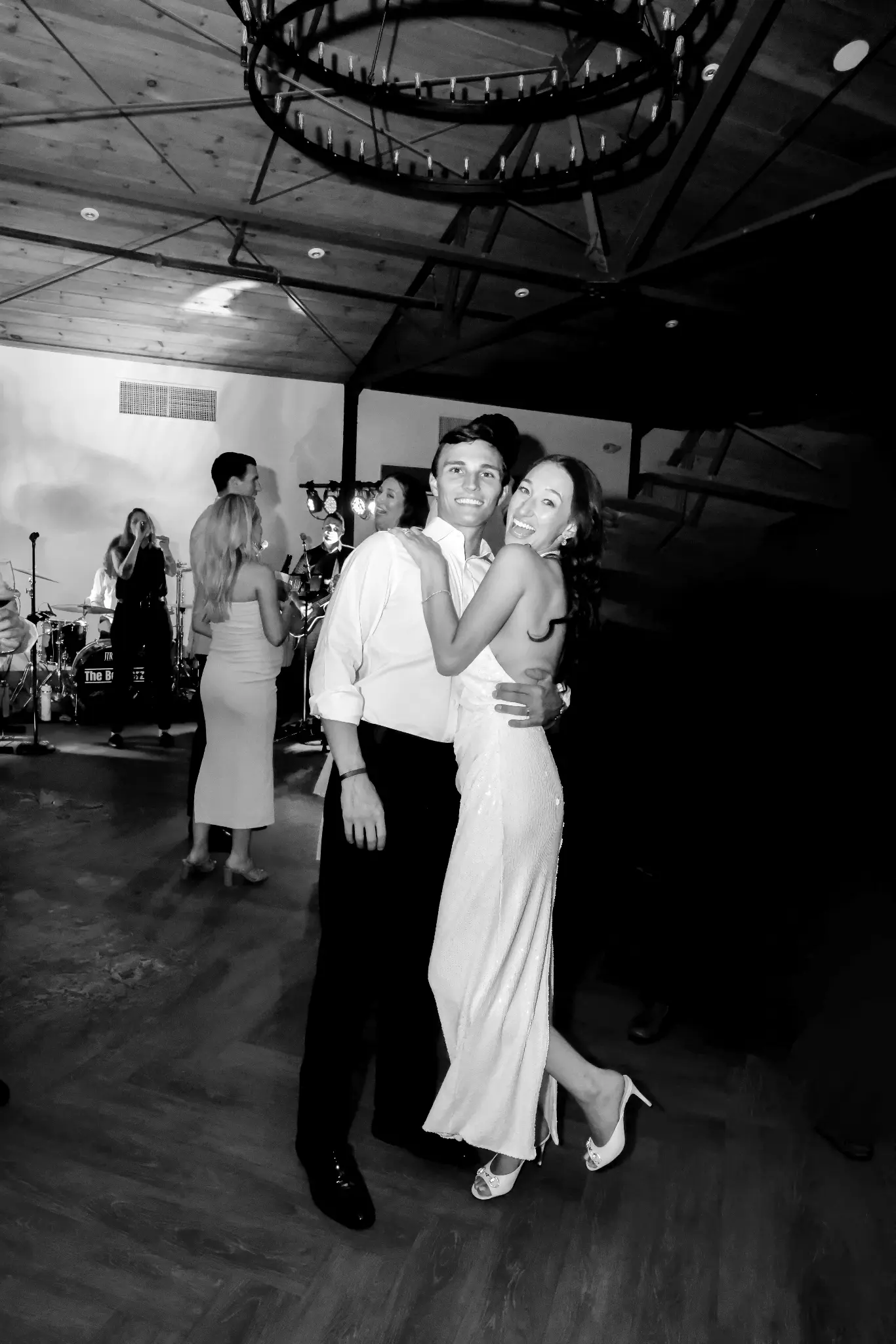 Black-and-white bride and groom dancing together at their wedding reception