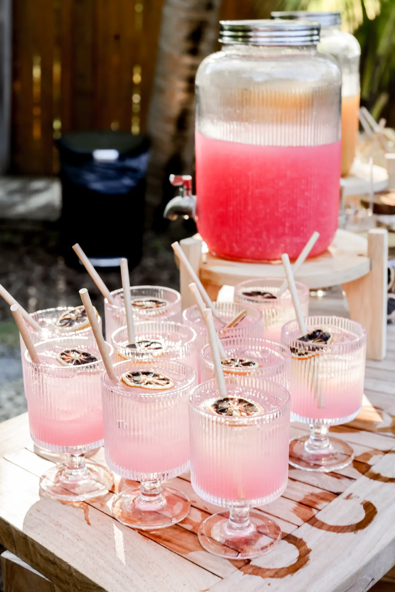 Pink cocktails arranged on a decorated wedding reception table
