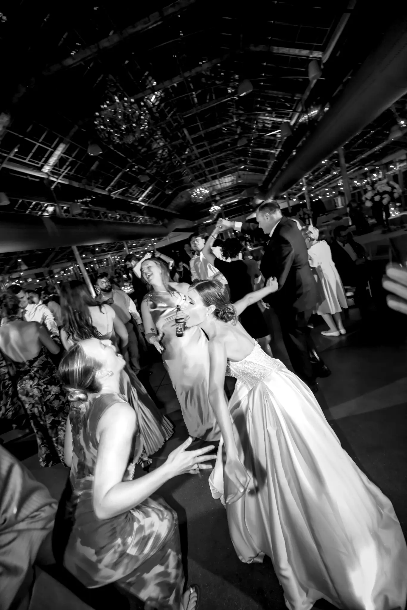 Black-and-white bride dancing with guests at her wedding reception