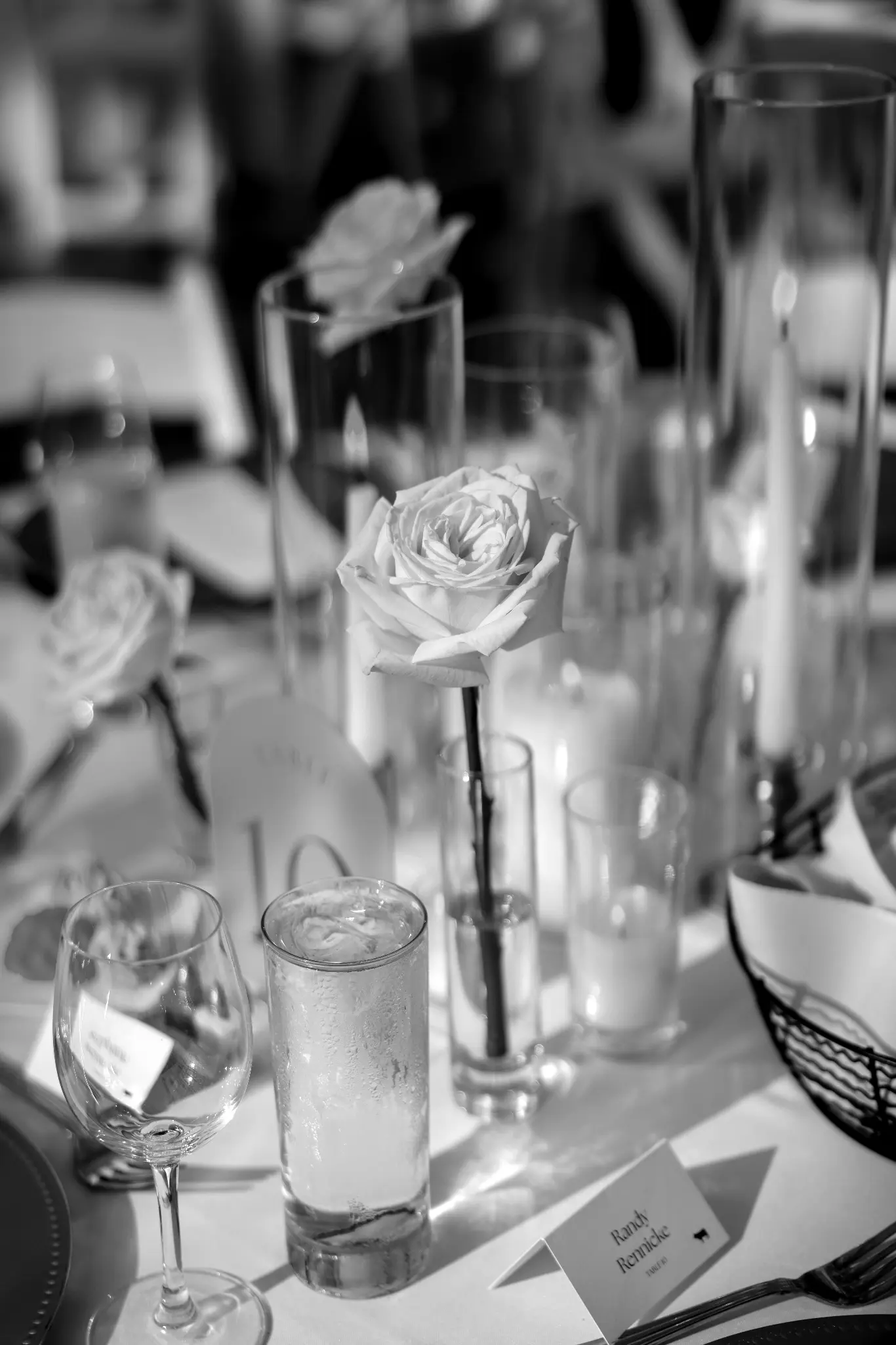 Candlelit wedding reception table with flowers, glassware, and place settings