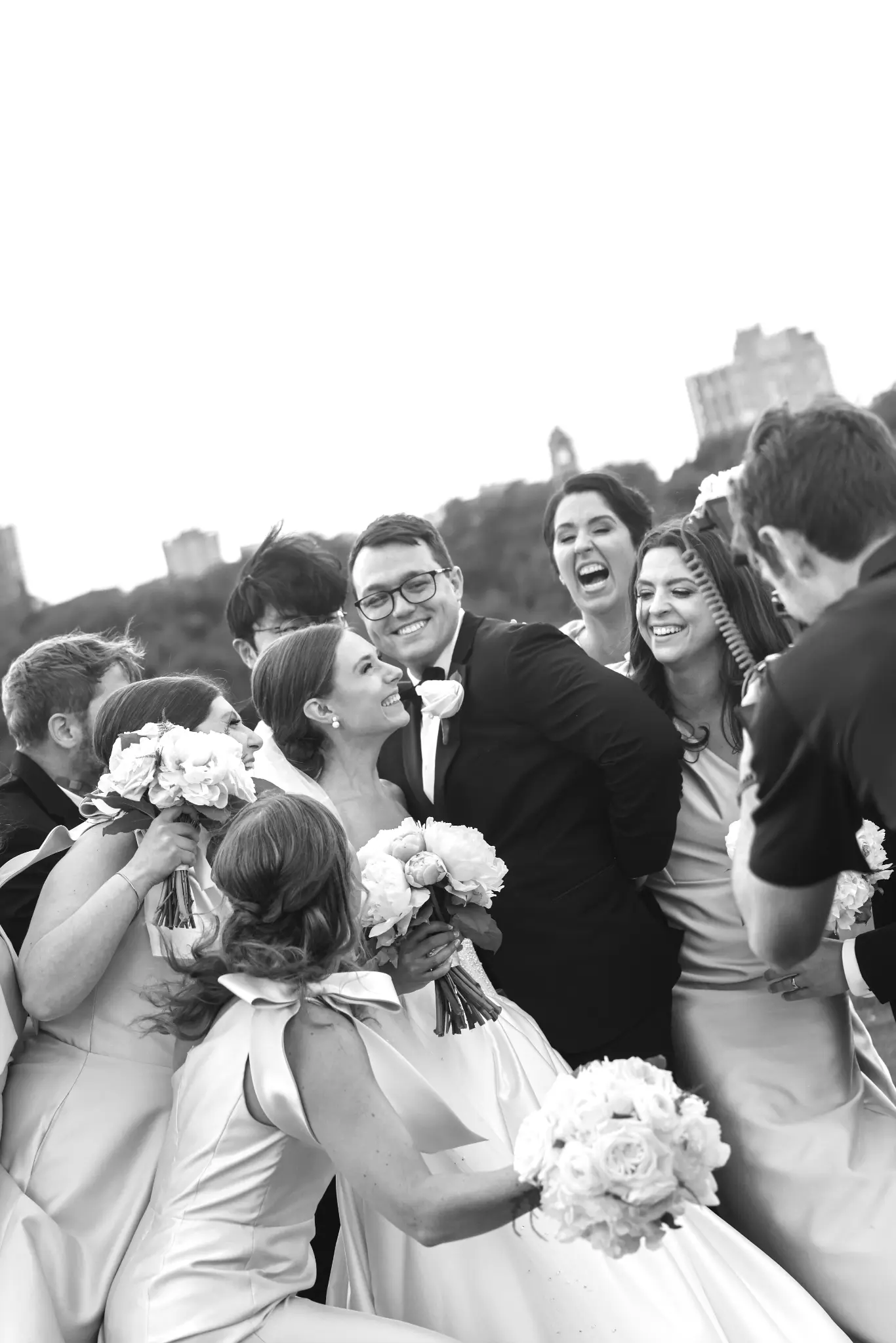 Black-and-white bride surrounded by wedding guests and bouquet details