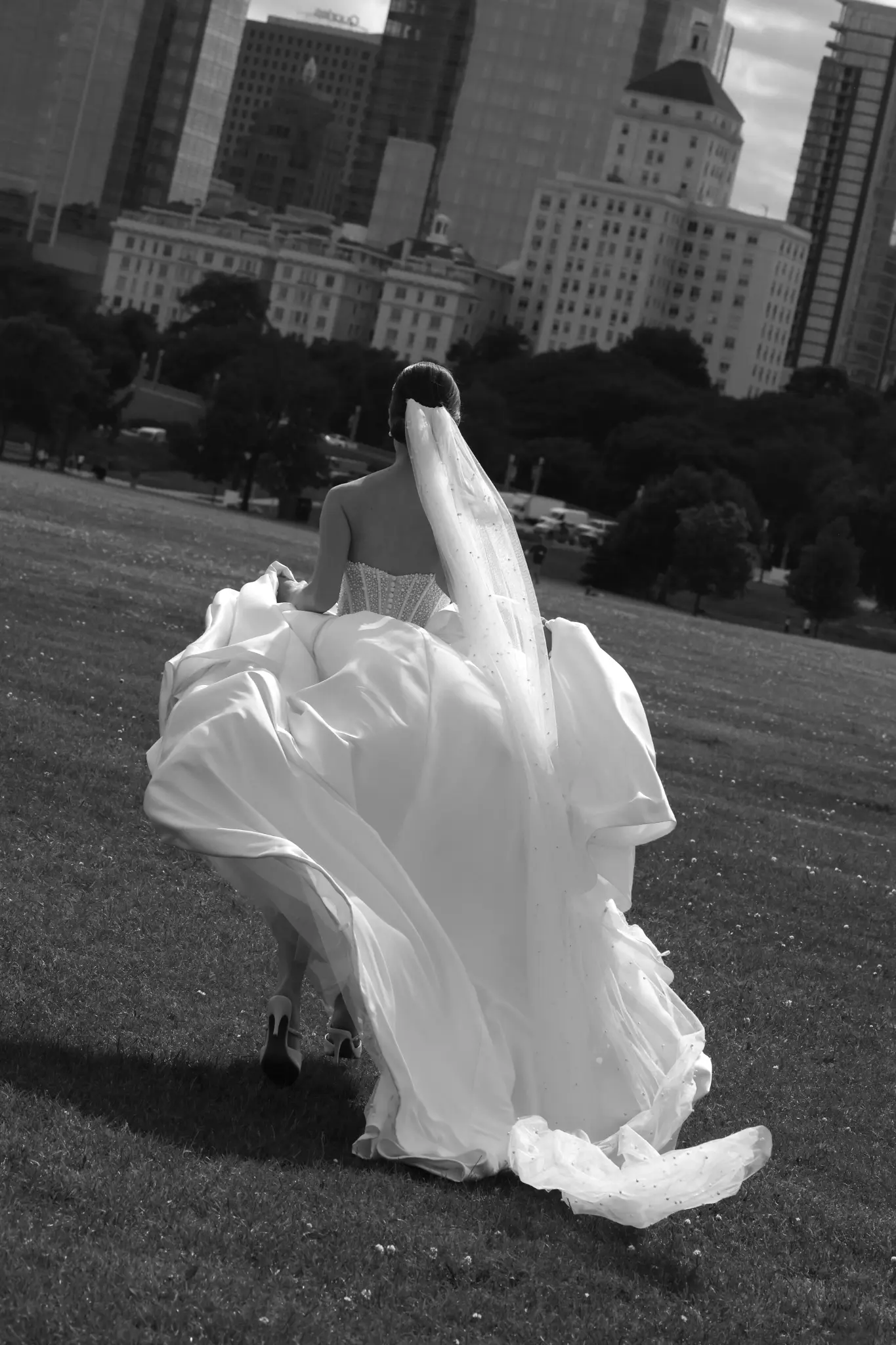 Black-and-white bride twirling in an urban garden
