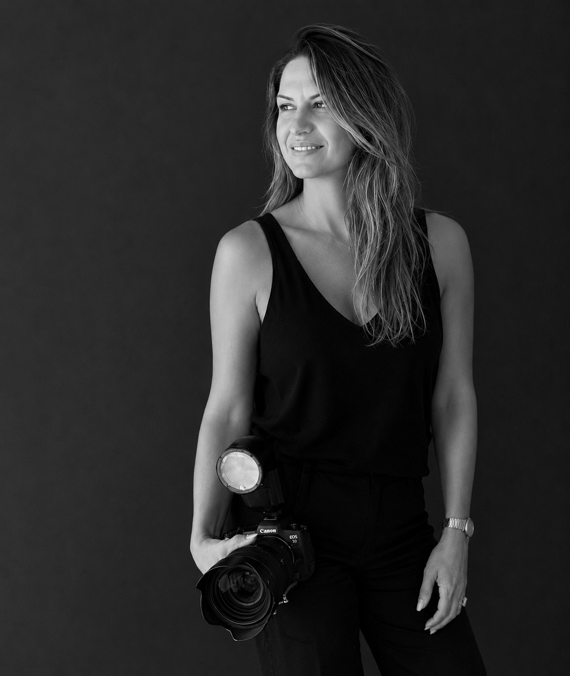 Olga Thomas holding her camera — destination wedding photographer